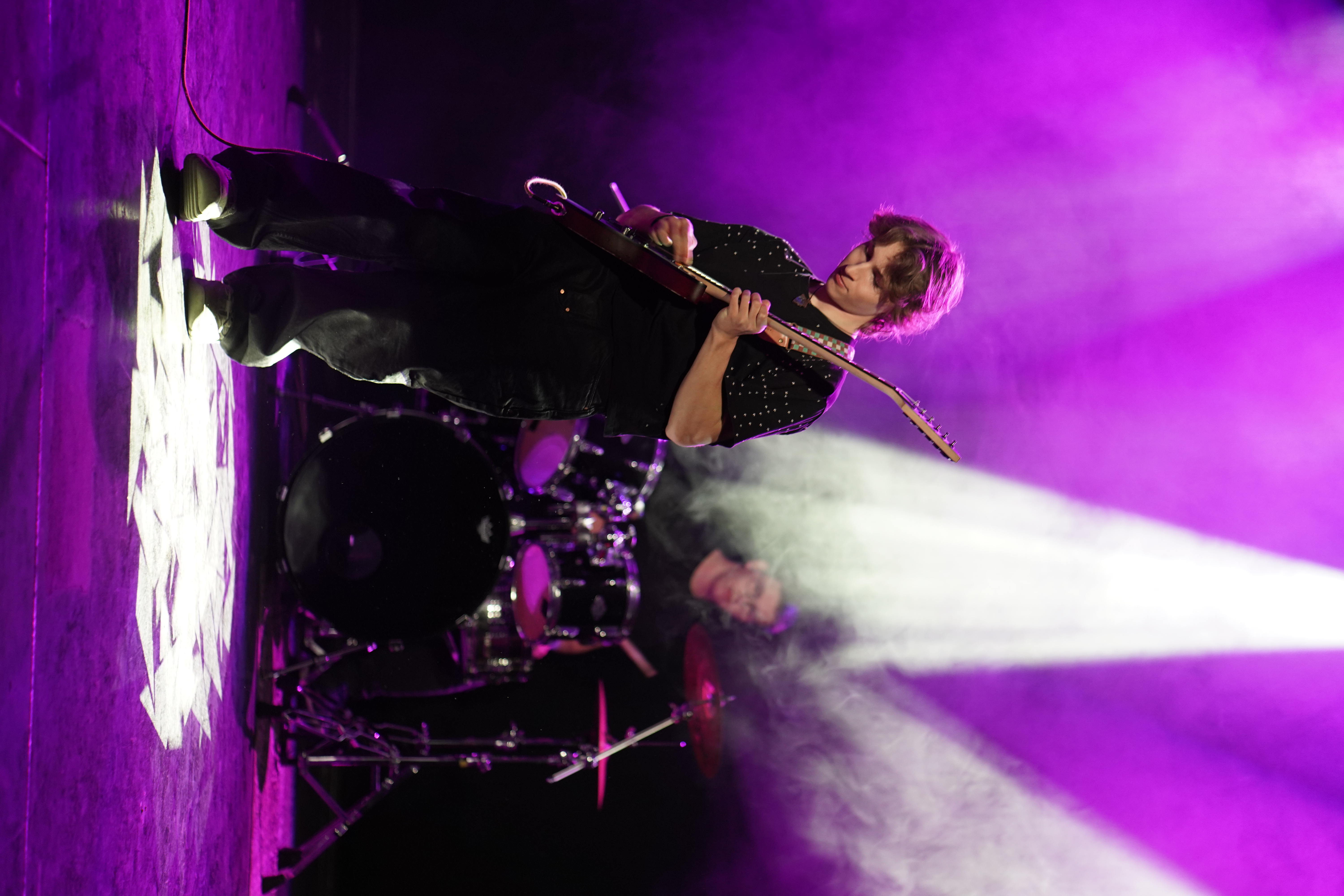 Premium musician playing under stage lights
